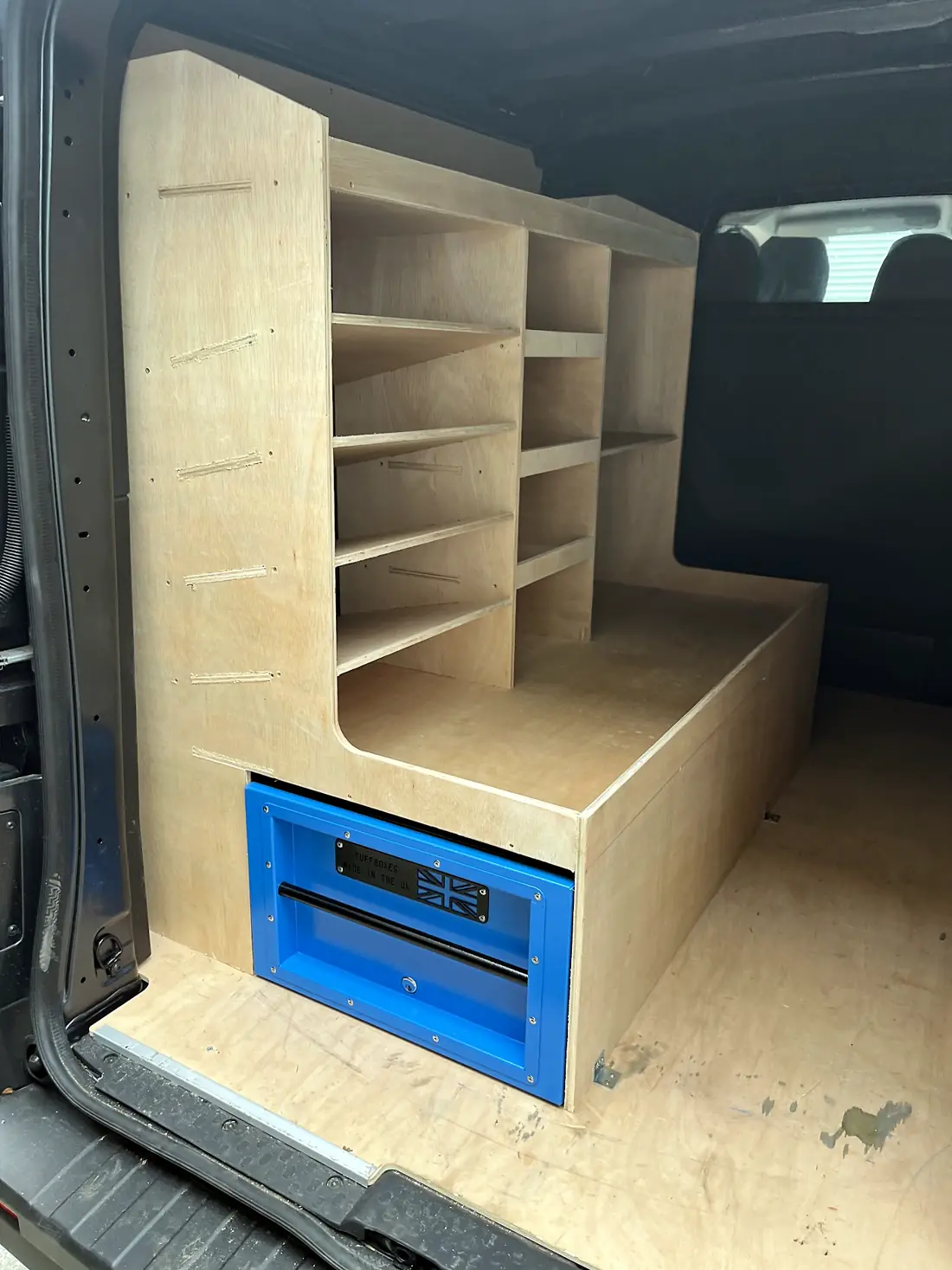Corner racking unit with a fitted toolbox drawer inside a van